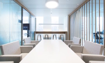 A table and chairs in a meeting room at an office